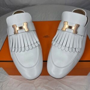 Hermès Rivoli White Leather with Gold Hardware Detail Fringe Loafer Mules